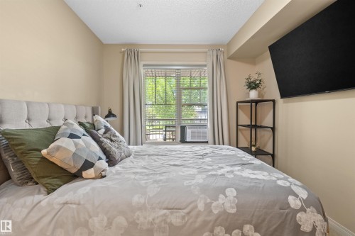 Window with blinds and drapes - #209 103 Ambleside Drive Sw, Edmonton, AB - Indoor Photo Showing Bedroom