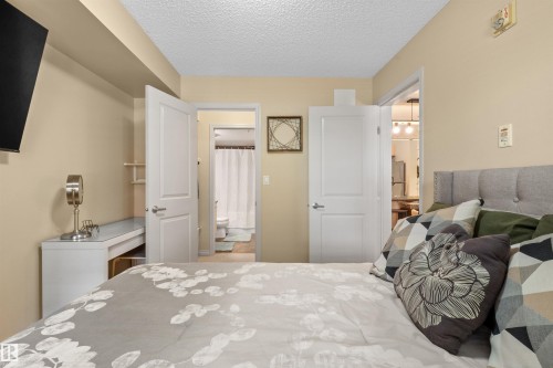 Recessed ceiling with an attached display shelf - #209 103 Ambleside Drive Sw, Edmonton, AB - Indoor Photo Showing Bedroom