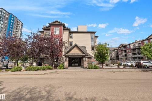 Multi-story building featuring varied facade materials, gabled entry, and mature landscaping - #209 103 Ambleside Drive Sw, Edmonton, AB - Outdoor With Facade