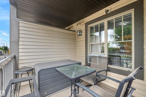 Covered balcony featuring horizontal siding, a framed window, and an exterior light fixture - #209 103 Ambleside Drive Sw, Edmonton, AB - Outdoor With Deck Patio Veranda With Exterior