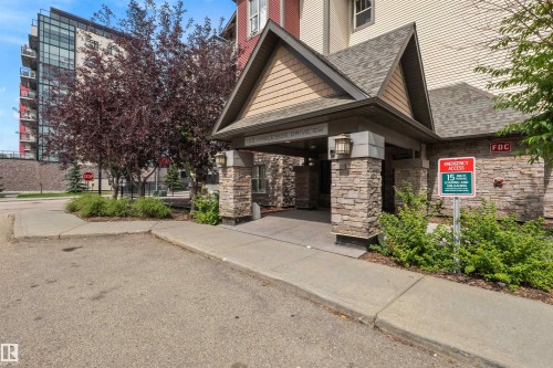 Stone veneer facade with wood-look siding accents - #209 103 Ambleside Drive Sw, Edmonton, AB - Outdoor