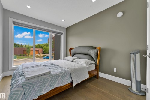 Room with a large window, recessed lighting, and wood-finish flooring - 9329 Connors Road Nw, Edmonton, AB - Indoor Photo Showing Bedroom