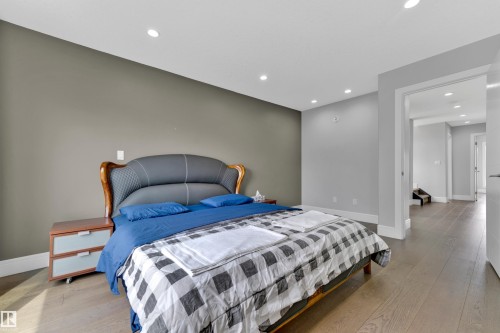 Recessed lighting illuminates this room featuring light wood-finish flooring and a neutral color palette - 9329 Connors Road Nw, Edmonton, AB - Indoor Photo Showing Bedroom