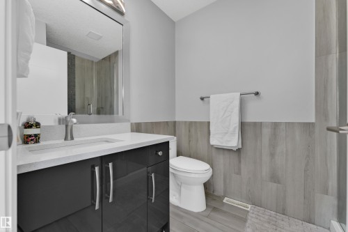 Vanity with a light-colored countertop and under-mount sink - 9329 Connors Road Nw, Edmonton, AB - Indoor Photo Showing Bathroom
