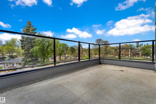 Outdoor patio featuring concrete flooring and modern glass railings with black frames - 9329 Connors Road Nw, Edmonton, AB - Outdoor With View