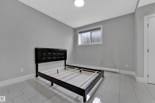 Room with light gray walls, white baseboards, and light-toned tile flooring - 9329 Connors Road Nw, Edmonton, AB - Indoor