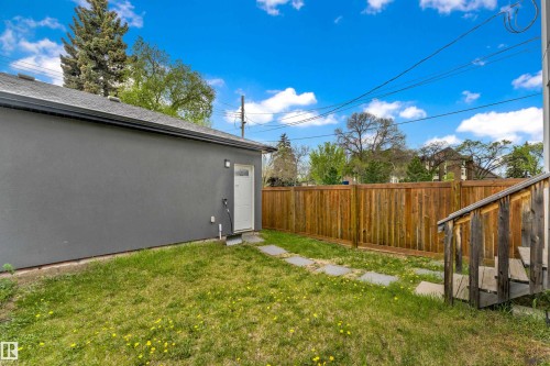 Detached structure with a textured gray exterior and a white service door - 9329 Connors Road Nw, Edmonton, AB - Outdoor
