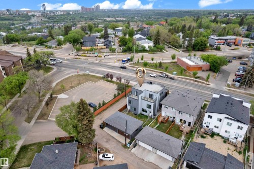 Modern multi-level exterior with a balcony and dark-framed windows, situated within a developed urban setting - 9329 Connors Road Nw, Edmonton, AB - Outdoor With View