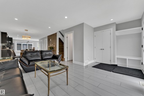 Polished light-toned flooring extends throughout the space, complemented by recessed lighting - 9329 Connors Road Nw, Edmonton, AB - Indoor Photo Showing Living Room