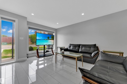 Bright living space featuring large windows, recessed lighting, and expansive white tile flooring - 9329 Connors Road Nw, Edmonton, AB - Indoor Photo Showing Living Room