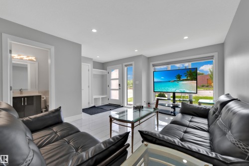 Spacious living area featuring white tile flooring and recessed lighting - 9329 Connors Road Nw, Edmonton, AB - Indoor Photo Showing Living Room