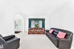 Arched entryway leading to double entry doors with oval glass inserts - 