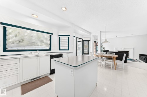 White kitchen cabinetry with a built-in dishwasher, an island with countertop, and recessed lighting - 209 Carmichael Close Nw, Edmonton, AB - Indoor Photo Showing Other Room