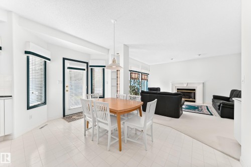 Open-concept living area with white walls and a white ceiling - 209 Carmichael Close Nw, Edmonton, AB - Indoor Photo Showing Dining Room