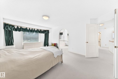 Wall-to-wall carpeting and white walls with a window featuring horizontal blinds - 209 Carmichael Close Nw, Edmonton, AB - Indoor Photo Showing Bedroom