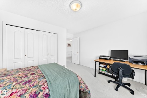 White walls with carpet flooring, flush mount lighting, and bi-fold closet doors - 209 Carmichael Close Nw, Edmonton, AB - Indoor Photo Showing Bedroom