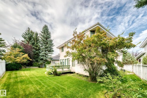Expansive lawn area, mature trees, privacy fencing, exterior deck, and established landscaping - 209 Carmichael Close Nw, Edmonton, AB - Outdoor
