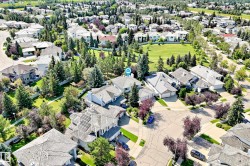 Expansive neighborhood with mature trees, green spaces, and a residential street network - 