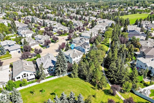 Residential neighborhood featuring mature trees, landscaped green spaces, and a paved pathway system - 209 Carmichael Close Nw, Edmonton, AB - Outdoor With View