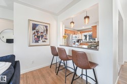 Kitchen pass-through with stone countertop and built-in breakfast bar - 