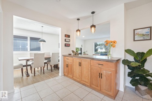 Tiled entry featuring a built-in wood-finish cabinet with a stone-finish countertop - 16613 90 Avenue Nw, Edmonton, AB - Indoor