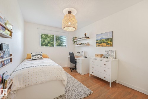 Wood-finish flooring with white walls and a window with blinds - 16613 90 Avenue Nw, Edmonton, AB - Indoor Photo Showing Bedroom