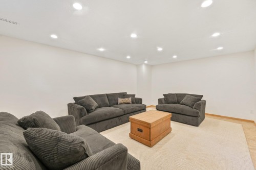 Recessed ceiling lighting illuminates a spacious room featuring light-colored carpeting - 16613 90 Avenue Nw, Edmonton, AB - Indoor