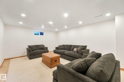 Recessed lighting, wall-to-wall carpeting, wood-finish flooring, and white painted walls - 16613 90 Avenue Nw, Edmonton, AB - Indoor Photo Showing Basement