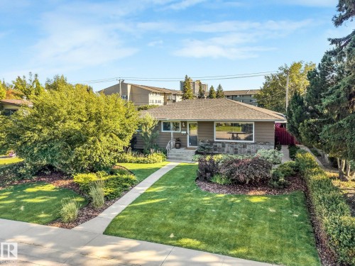 Single-story residence featuring a gabled roof, stone veneer detailing, and a front walk - 16613 90 Avenue Nw, Edmonton, AB - Outdoor