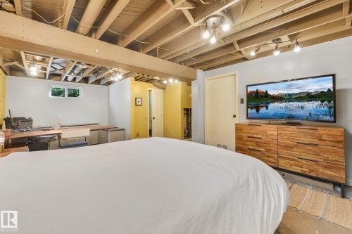 Exposed ceiling joists with track lighting, recessed lighting, and a beam - 16613 90 Avenue Nw, Edmonton, AB - Indoor