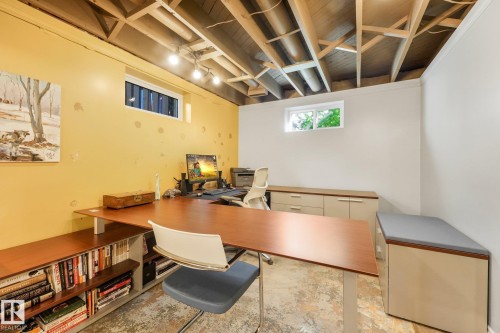 Spacious lower level room with an exposed beam ceiling, recessed lighting, and two windows - 16613 90 Avenue Nw, Edmonton, AB - Indoor