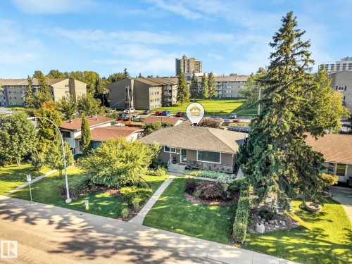 Single-story exterior with a gabled roof, front lawn, mature trees, and established landscaping - 16613 90 Avenue Nw, Edmonton, AB - Outdoor