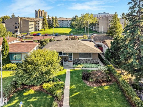 Single-story residence featuring a shingle roof and a stone facade accent - 16613 90 Avenue Nw, Edmonton, AB - Outdoor