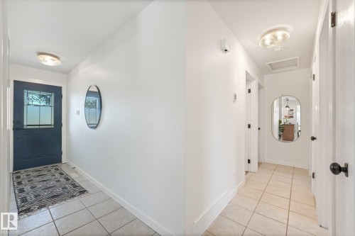 Tile flooring throughout, with a decorative entry door featuring leaded glass - 16613 90 Avenue Nw, Edmonton, AB - Indoor Photo Showing Other Room