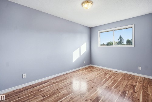 Wood-finish flooring with varied grain patterns - 3432 Hill View Crescent Nw, Edmonton, AB - Indoor Photo Showing Other Room