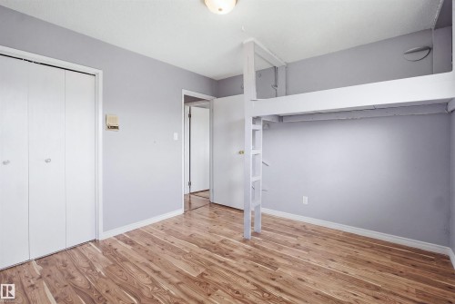 Wood-finish flooring, built-in loft structure, and bi-fold closet doors - 3432 Hill View Crescent Nw, Edmonton, AB - Indoor Photo Showing Other Room