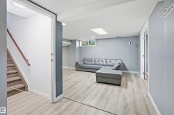 Finished lower level with light wood-finish flooring, recessed lighting, drop ceiling, and a single window - 