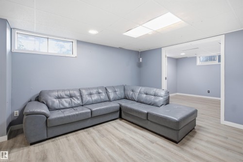 Recessed lighting, wood-finish flooring, white trim, and a window - 3432 Hill View Crescent Nw, Edmonton, AB - Indoor Photo Showing Other Room