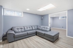 Recessed lighting, wood-finish flooring, white trim, and a window - 