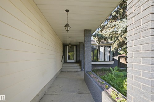 Covered entry with recessed lighting, concrete steps, and brick facade accents - 3432 Hill View Crescent Nw, Edmonton, AB - Outdoor