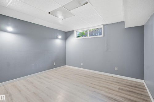 Recessed lighting, drop ceiling, wood-finish flooring, white trim, and a horizontal window - 3432 Hill View Crescent Nw, Edmonton, AB - Indoor Photo Showing Other Room