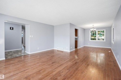 Hardwood flooring extending throughout the main living space - 3432 Hill View Crescent Nw, Edmonton, AB - Indoor Photo Showing Other Room