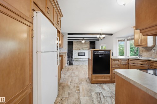 Kitchen featuring wood cabinetry, light-toned countertops, and tile flooring - 3432 Hill View Crescent Nw, Edmonton, AB - Indoor Photo Showing Kitchen
