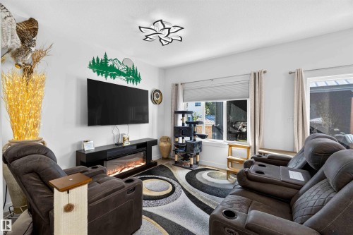 Bright interior with white walls, recessed window, and contemporary ceiling light fixture - 91 Hilton Cove, Spruce Grove, AB - Indoor Photo Showing Living Room