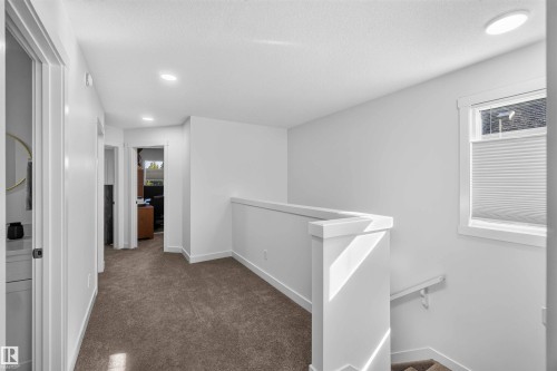 White walls with recessed lighting, brown carpeted flooring, and a white window with cellular shades - 91 Hilton Cove, Spruce Grove, AB - Indoor Photo Showing Other Room