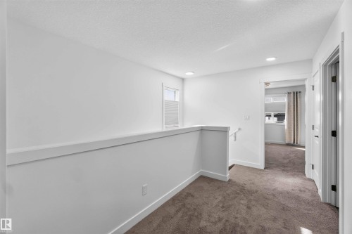 Carpeted hallway featuring white walls, a white railing, and recessed ceiling lighting - 91 Hilton Cove, Spruce Grove, AB - Indoor Photo Showing Other Room