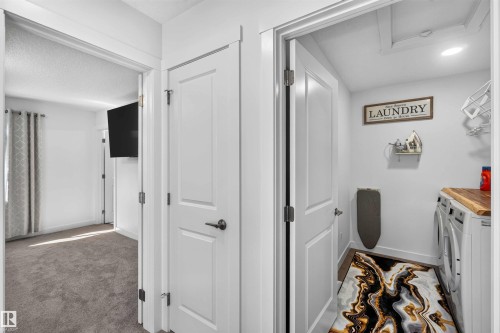 Dedicated laundry area featuring a wood-finish countertop - 91 Hilton Cove, Spruce Grove, AB - Indoor Photo Showing Other Room