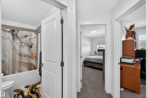 Hallway featuring white paneled doors, neutral carpeting, and recessed lighting - 91 Hilton Cove, Spruce Grove, AB - Indoor