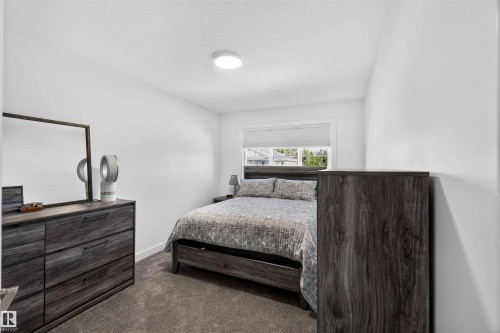 Plush carpeting, window with roller shade, and a flush-mount ceiling light - 91 Hilton Cove, Spruce Grove, AB - Indoor Photo Showing Bedroom