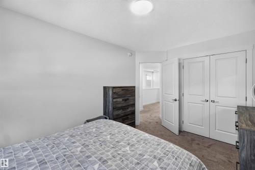 Recessed ceiling light, white interior doors, and carpeted flooring - 91 Hilton Cove, Spruce Grove, AB - Indoor Photo Showing Bedroom